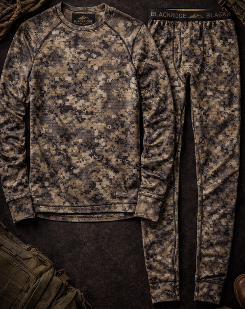 Camouflage long-sleeve shirt and pants on a dark surface with tactical gear.