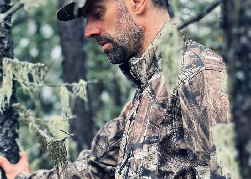 Man in camouflage clothing in a forest setting